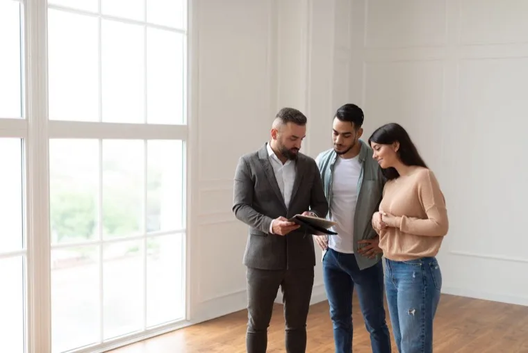 An agent talking buyers through their options in a bright home